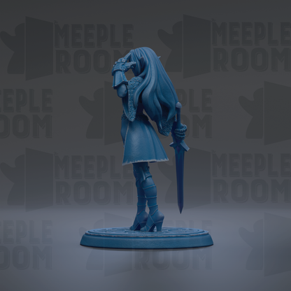 A blue figurine of a woman holding a sword and shield, standing on a circular base.