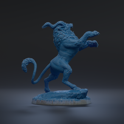 A blue, sculpted statue of a mythical creature with horns and a fierce expression, standing on a rock.