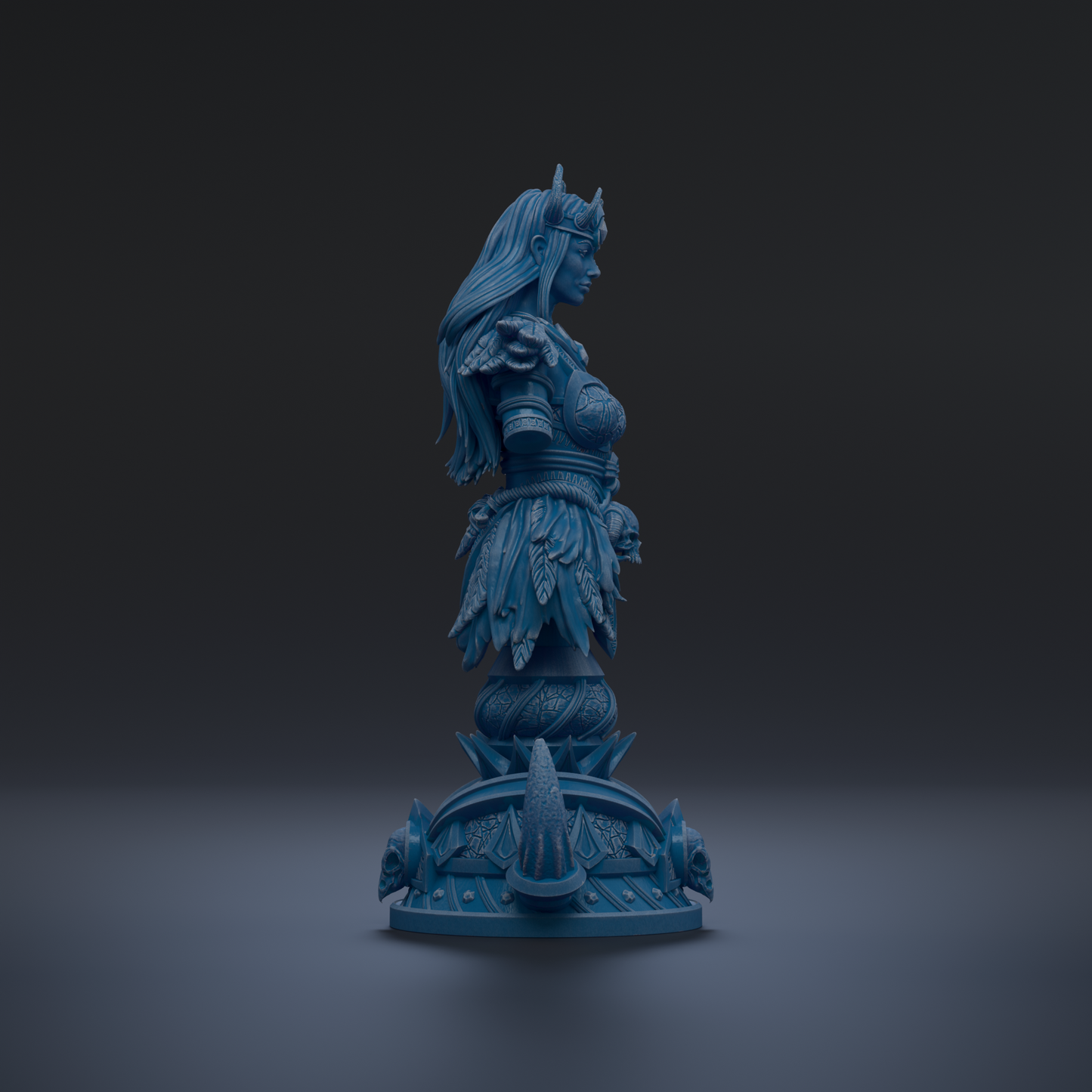 A blue statue of a woman with long hair and a crown, standing on a pedestal with intricate designs.