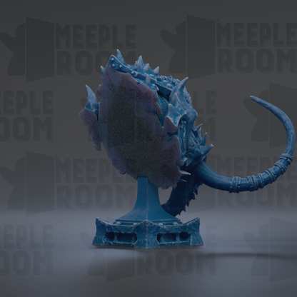 A blue, fantastical creature resembling a dragon or serpent, with sharp teeth and a long, curved tail, is displayed on a pedestal against a dark background.