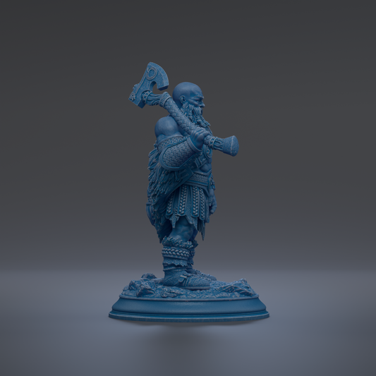 A blue figurine of a bearded man holding a large weapon, standing on a base.