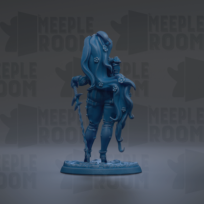 A blue figurine of a woman with long hair and a flowing skirt, holding a staff, is the central focus of the image.