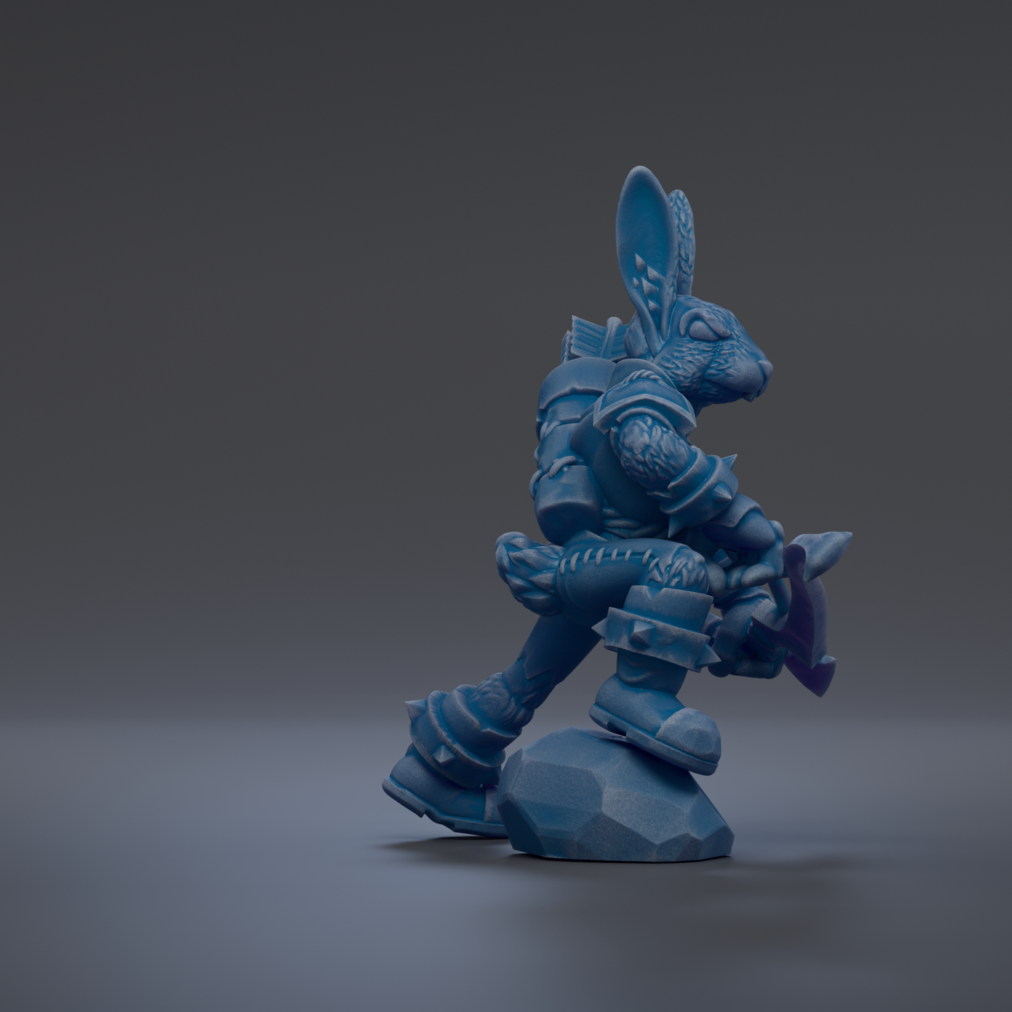 A blue, armored figurine holding a weapon and standing on a rock against a dark background.