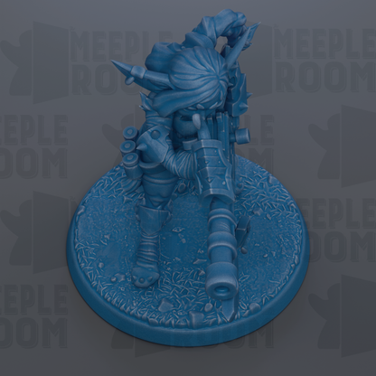 A blue figurine of a character with a gun, standing on a textured base.