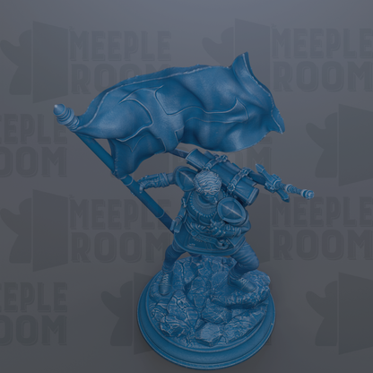 A blue statue of a person holding a flag, standing on a rocky base.