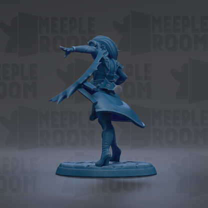 A blue figurine of a person with a flowing skirt and a pointed hat, standing on a platform and pointing with one hand.