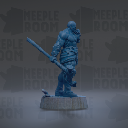 A blue figurine of a muscular warrior standing on a pedestal, holding a weapon.