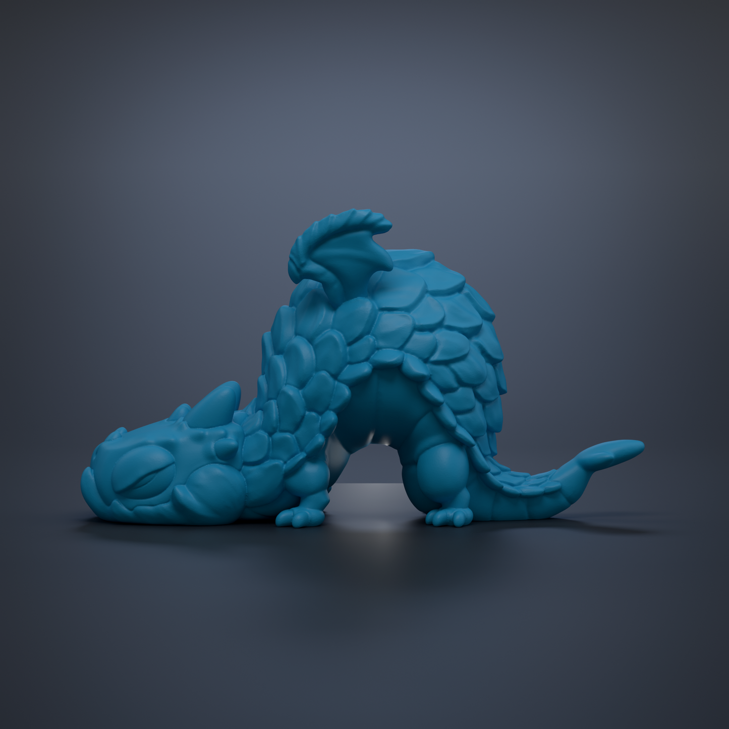 A blue, 3D-rendered dragon figurine is depicted in a resting position against a dark background.
