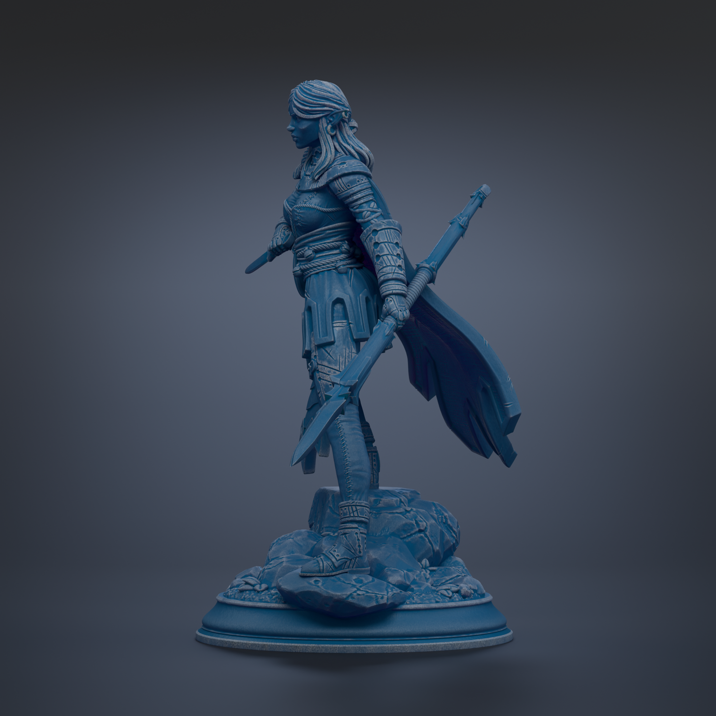 A blue statue of a female warrior standing on a rock base, holding a sword and shield.