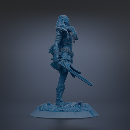A blue statue of a female warrior standing on a base, holding a sword and wearing ornate armor.