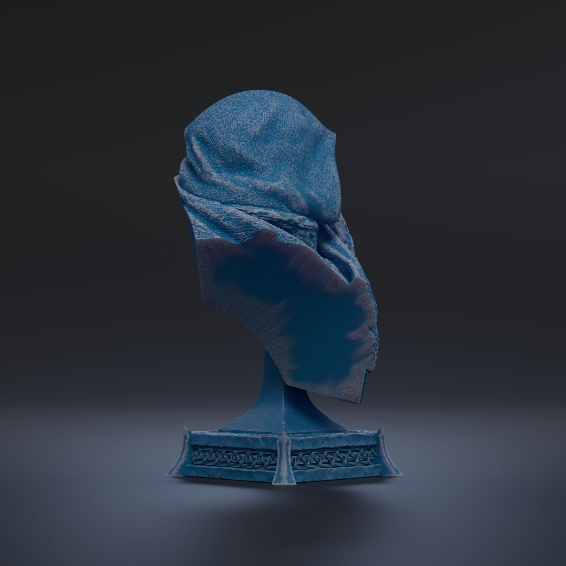 A blue, textured object is displayed on a pedestal against a dark background.