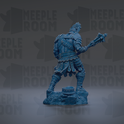 A blue statue of a warrior figure holding a weapon and standing on a rock formation.