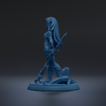 A blue figurine of a woman with long hair and a sword, standing on a base.