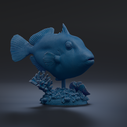 A 3D rendering of a blue fish sculpture, with its fins and tail visible, sitting on a base with coral and other marine life.