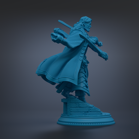 A blue statue of a person with long hair and a beard, holding a sword and standing on a pedestal.
