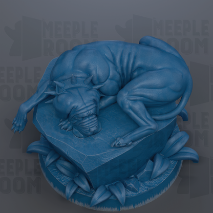 A blue, sculpted statue of a dog lying on a rock, surrounded by leaves.