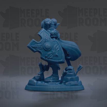 A blue figurine of a person holding a shield and standing on a rock formation.