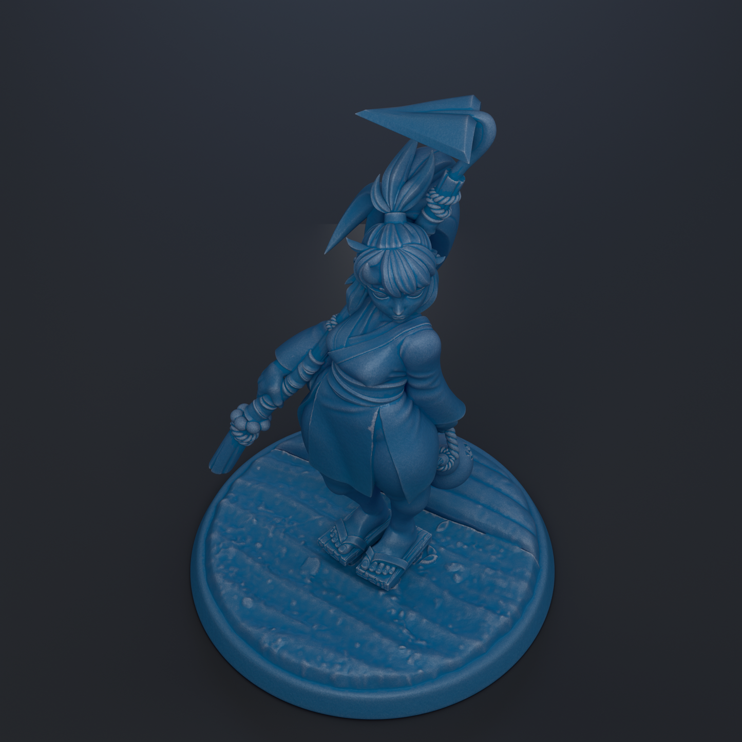 A blue figurine of a person standing on a circular base, holding a weapon in their hand.