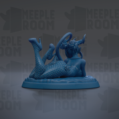 A blue figurine of a woman with fishnet stockings and high heels, lying on her back with her legs crossed, is the main focus of the image.