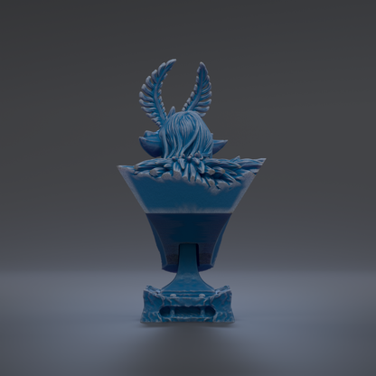 A blue ceramic sculpture with a stylized bird-like figure on top, set against a dark background.