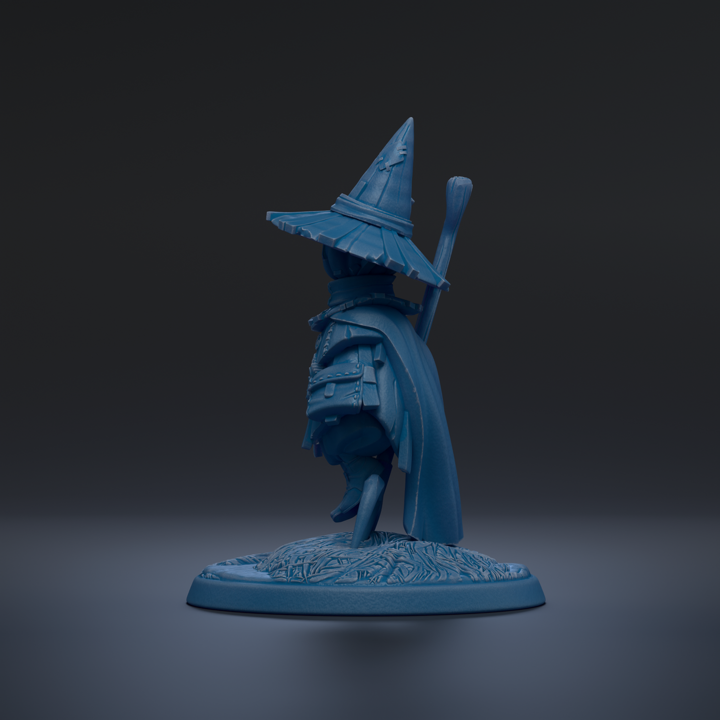A blue figurine of a wizard or magical character wearing a pointed hat and holding a staff, standing on a base with a floral design.