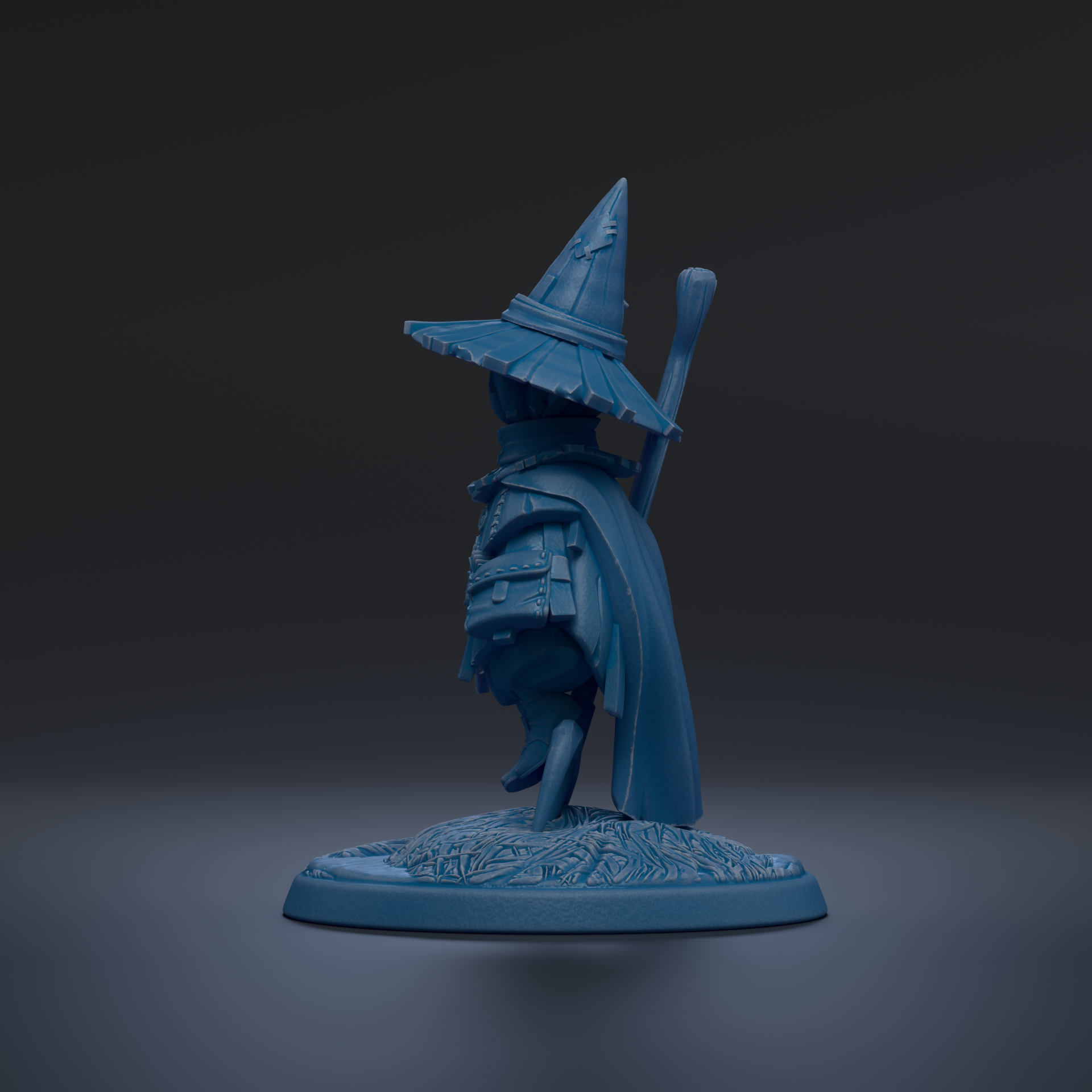 A blue figurine of a wizard or magical character wearing a pointed hat and holding a staff, standing on a base with a floral design.