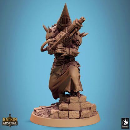 A 3D model of a character with a pointed hat and a large gun, standing on a base made of small rocks.