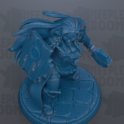A blue figurine of a female character with long hair and a shield, standing on a stone base.