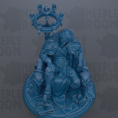 A blue statue of a person sitting on a throne, with a chandelier above them.