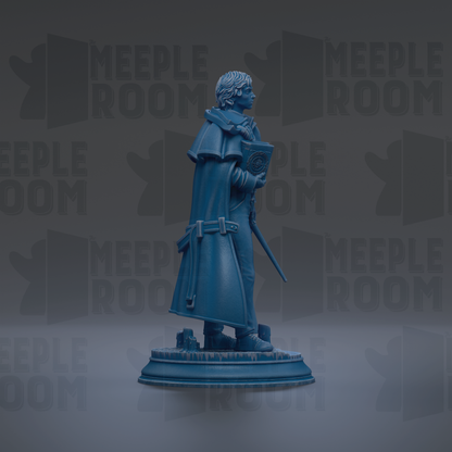 A blue statue of a person standing on a pedestal, holding a book and a staff.