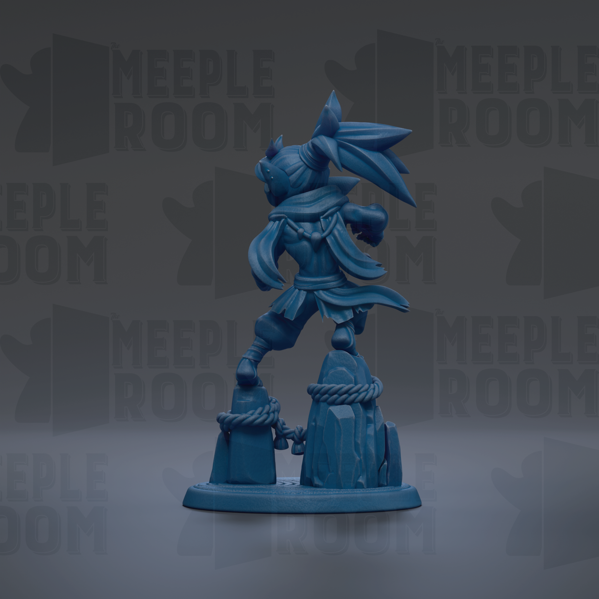 A blue figurine of a character with a flowing cape and a large headdress, standing on a rock formation.