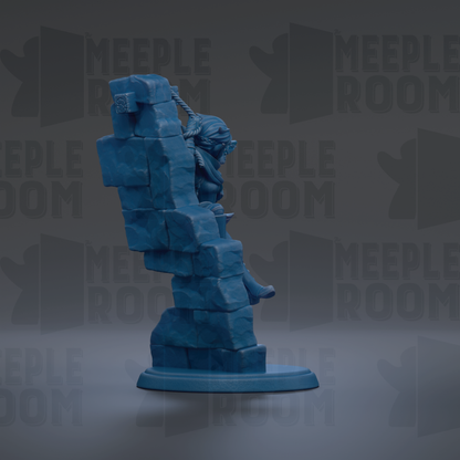 A blue figurine of a person sitting on a stack of blocks, with the word "MEUPLEROOM" repeated in the background.