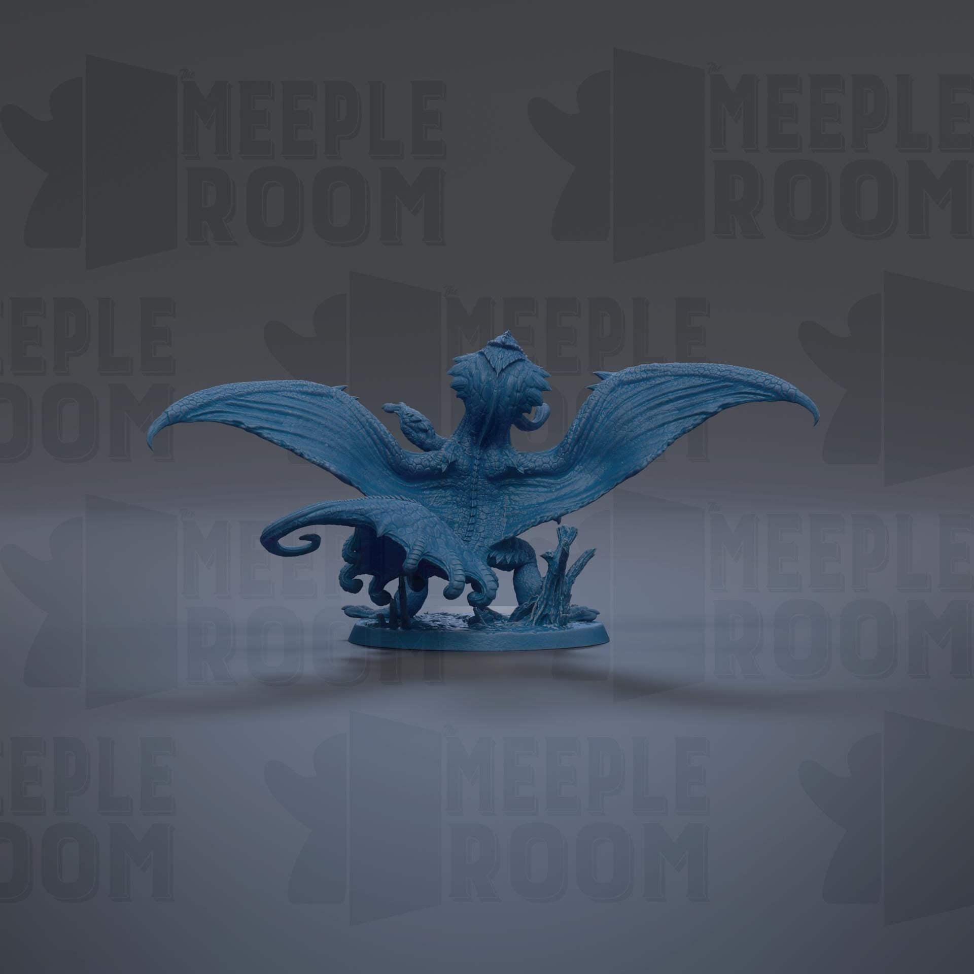 A blue dragon figurine with wings spread, standing on a base with mushrooms and plants.